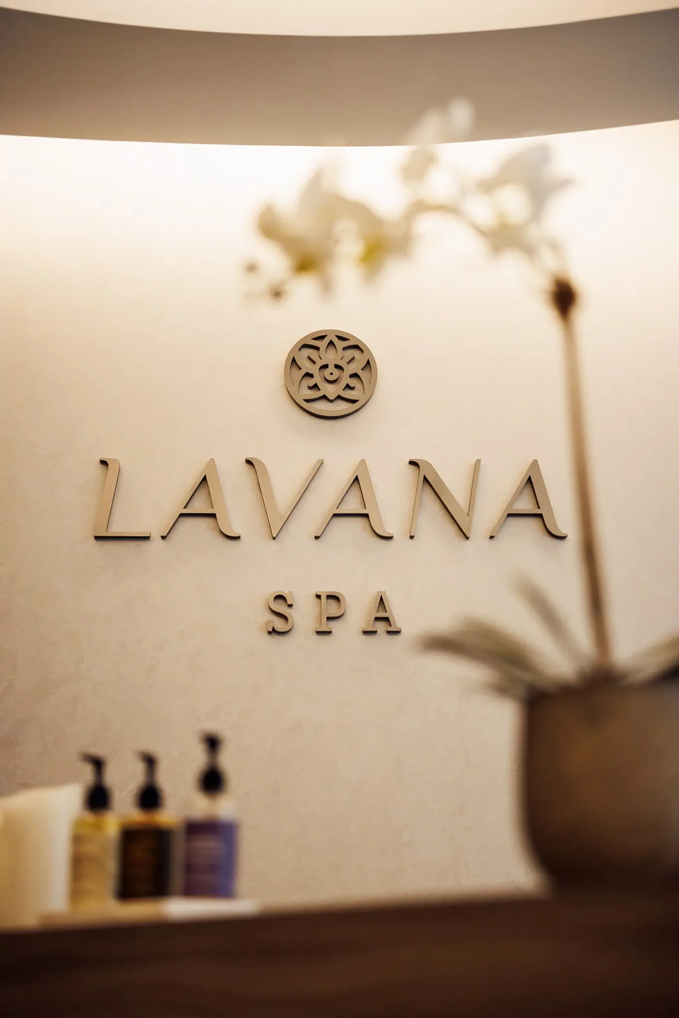 Lavana Spa lettering and emblem on the wall above the reception counter at the DIFC branch