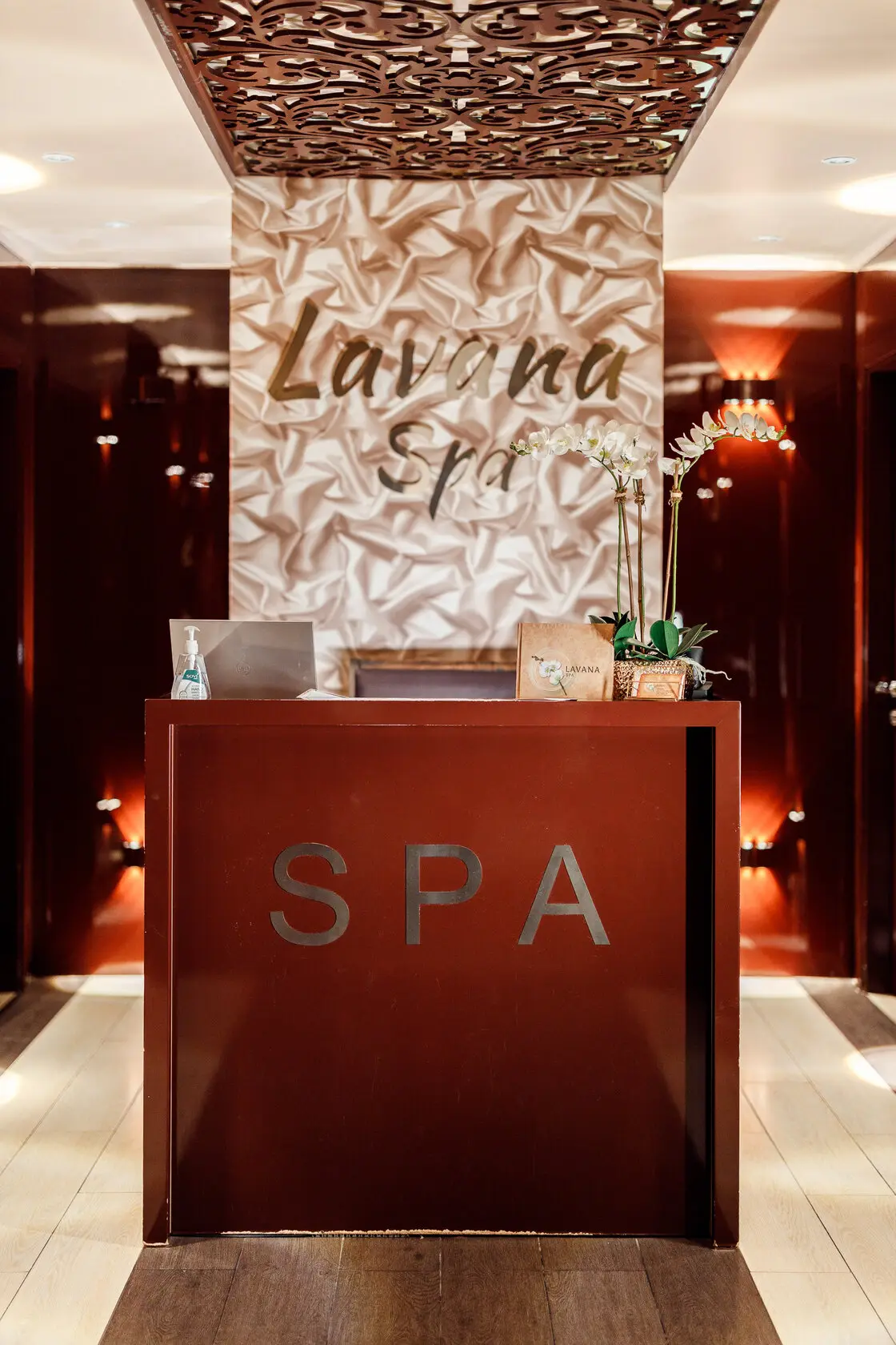 Reception desk at Lavana Spa Al Barsha, with the spa sign above it