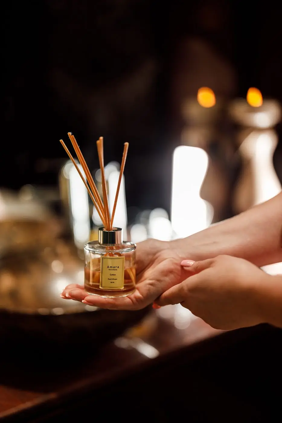 Reed diffuser held in front of the candlelit console at the Al Barsha branch
