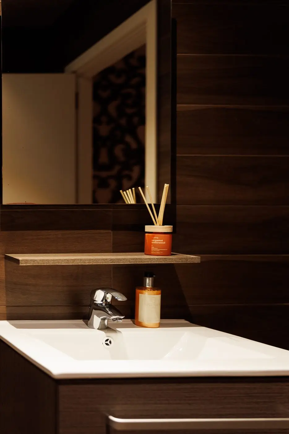 Washbasin and mirror in the treatment room bathroom at Bur Dubai